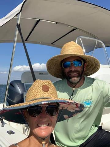 A couple taking a selfie on their pathfinder boat.